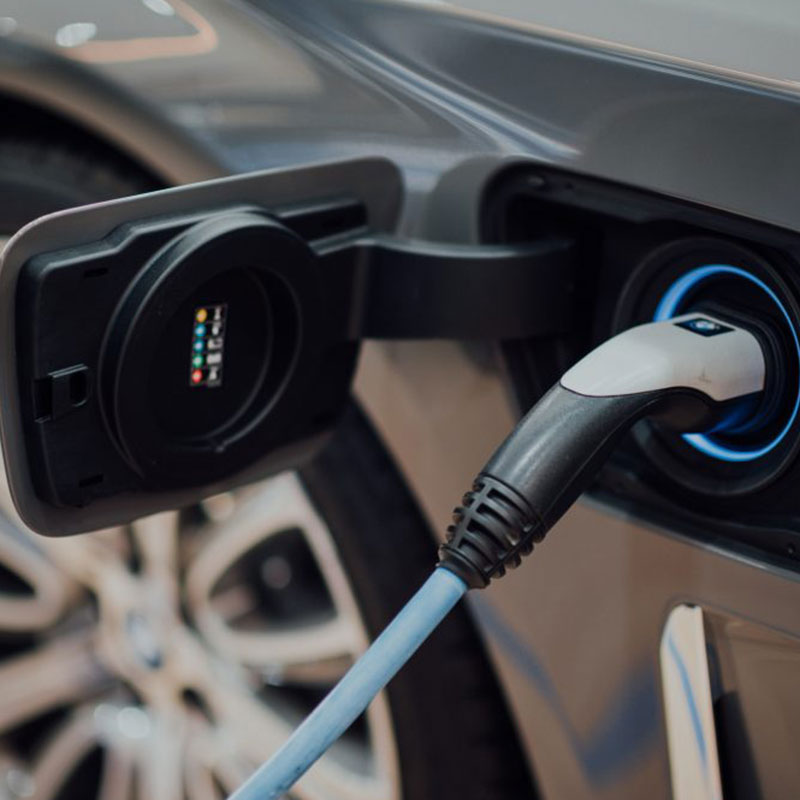 Electric vehicle charging in car at ITC Limited installation showing eco friendly energy solution